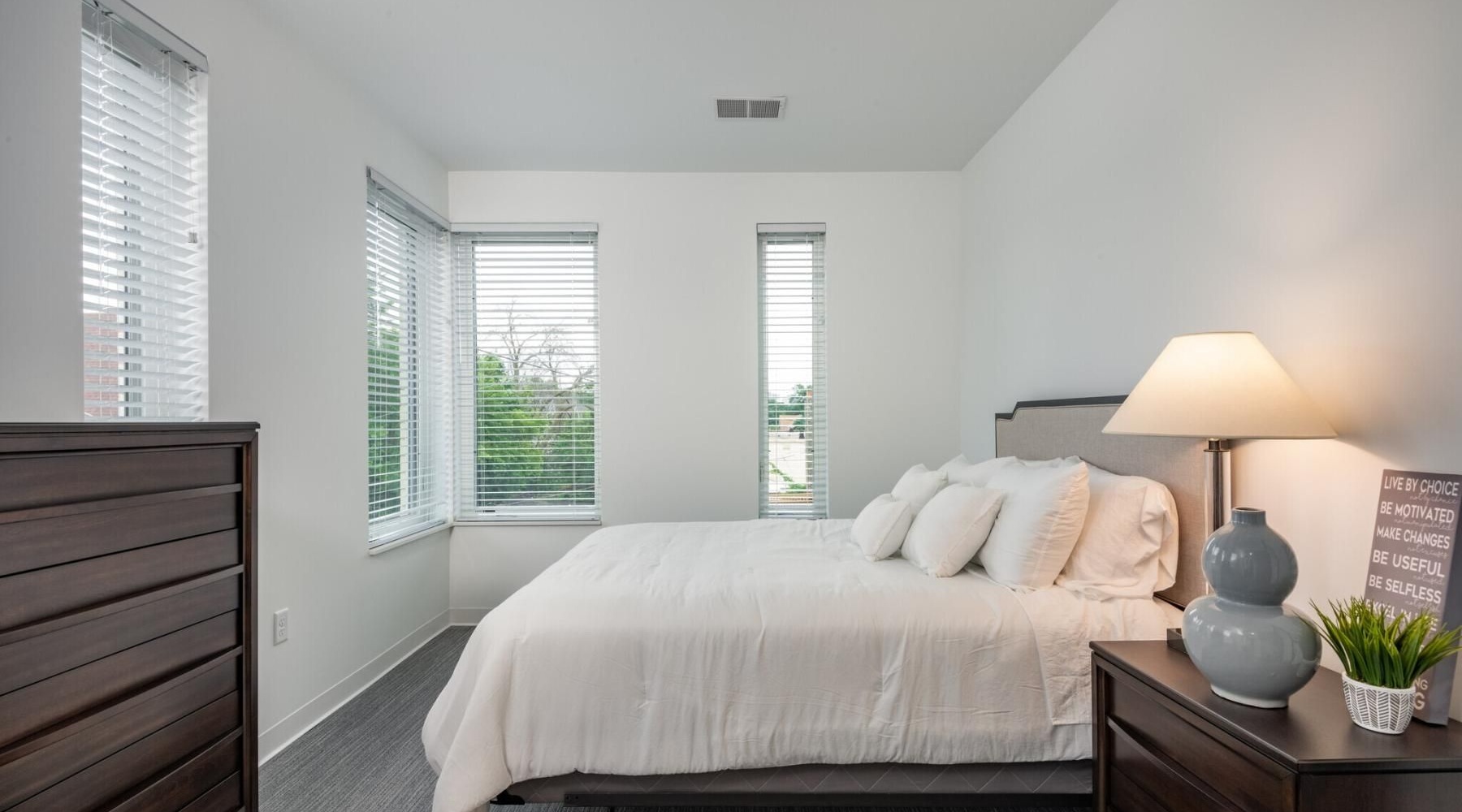 a bedroom with a bed and a lamp