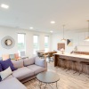 a large living room with a bar and a dining table