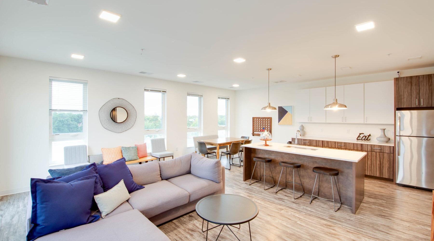 a large living room with a bar and a dining table